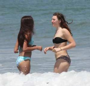 Brunette and redhead on the beach in bikinis looking sexy