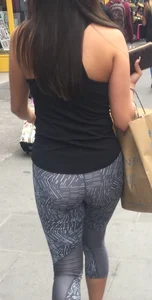 Sexy girl walking in grey patterned leggings with friend in tight jeans