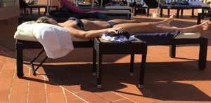 Blonde laying out in a blue bikini with a sexy body