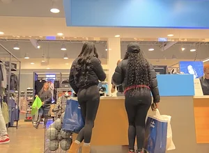 Two ebony girls in leggings at the register