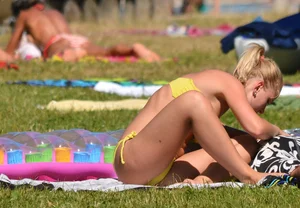 Blonde looking sexy in a yellow bikin