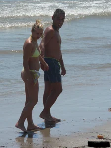 Sexy blonde on the beach in a yellow thong bikini
