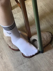 Creepshot of a Teen Girl's Feet in White Socks With Slippers Taken Off