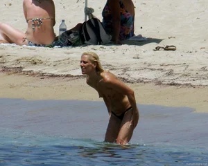 Small boobed topless milf on the beach