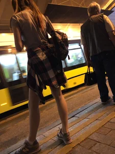 Cute Teen in Shorts on the Tram Stop