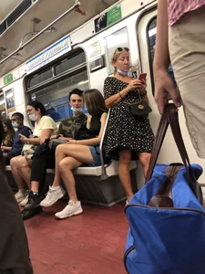 Hot Girl With Gorgeous Legs in Jean Shorts And Sneakers Sitting in a Subway Train With Crossed Legs - Touching And Swinging Her Legs