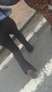 Girl with a nice ass in leggings walking down the street