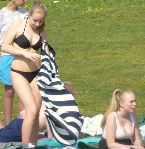 Teen taking off her dress in the park