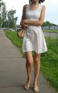 Sexy lady in a dress and high heeled sandals with slim legs suburban street creepshots