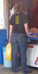Booties of street candid girls wearing tight jeans