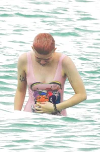 Miley Cyrus' friend in pink see through swimsuit showing nipples and pussy hair