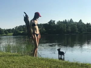 Skinny Girl in Swimsuit with Small Breast on the Shore of a Lake