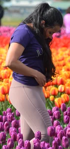 Cute babe in tight leggings taking pictures in flower fields