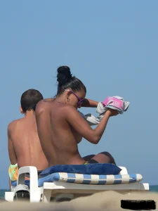 Hot ass topless beach girl with great tits lets her little brother oil up her ass in thong bikini