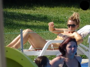 Topless lady at the pool with nice tits