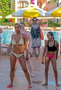 Big boobed blonde milf dancing by the pool in a bikini