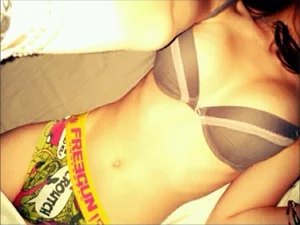 Sexy And Skinny Girl in Underwear With a Nice Stomach Lying in Bed Selfie