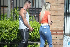 Blonde in skintight jeans shopping with boyfriend