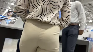 Plus Face shot - Gorgeous AT&T babe in beige pants  touching her ass with long red nails