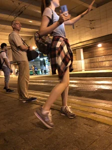 Cute Teen in Shorts on the Tram Stop