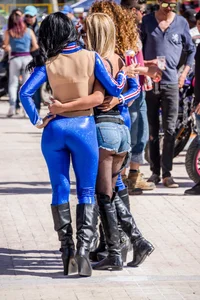 Sexy car models in tight shiny blue legging type pants