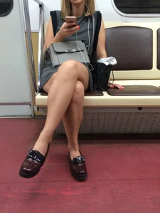 Girl in a Short Dress a Subway Train with Legs Crossed