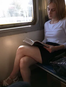 Train Candid Girl with Sexy Legs Reading a Book