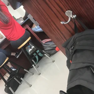 Booty of a College Girl in Tights Sitting on the Bar Stool in the Class