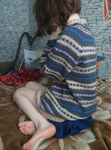 Skinny Girl in a Sweater Sitting on Bed Barefoot Home Candid