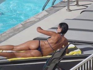 Hot milf sunbathing in a thong by pool and swimming
