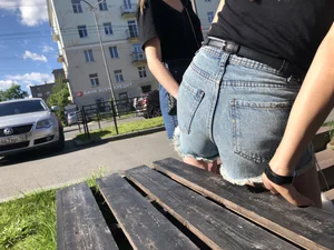 Girl in Denim Shorts with Amazing Hot Legs Fixing Her Sandals Street Candid Photo Gallery