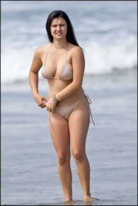 Sexy brunette chick at the beach with big tits and a nice ass in thong bikini