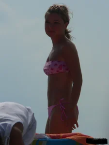 A bunch of hot babes on the beach in thong bikinis