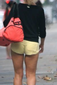 Blonde looking sexy walking in short yellow shorts