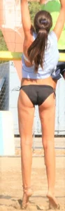 Hot girls playing beach volleyball in bikinis and shorts