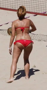 Redhead with nice ass and back dimples in red bikini on the beach