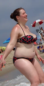 Fat chick with big boobs at the beach in a bikini