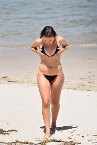 Blue bikini girl on the beach with a great ass and a little pussy lips slips