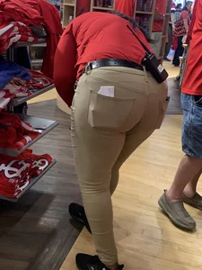 Bunch of girls in various outfits at a Cardinals baseball game