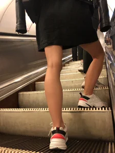 Blonde in a Dress and Sneakers With Sexy Skinny Legs in the Subway Train and on the Escalator Closeup Candid Photos