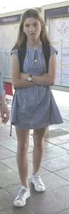Cute girl wearing a dress at the train station