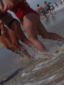 Fat chick on the beach in a red swimsuit