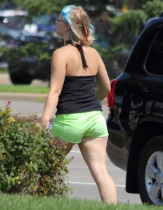 Blonde girl in glasses with a thick booty in green shorts