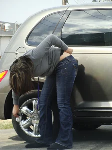 Girl cleaning her car in jeans and showing some cheetah print underwear