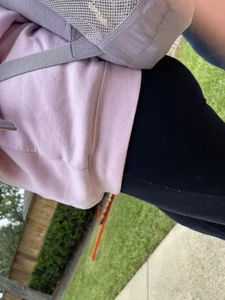 Firm ass in leggings closeup, a college teen with a backpack passing by in a suburban neighborhood