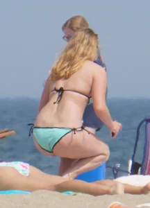 Cute girls in light blue and purple bikinis on the beach
