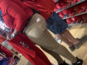 Bunch of girls in various outfits at a Cardinals baseball game
