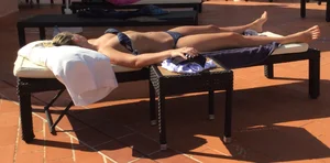 Blonde laying out in a blue bikini with a sexy body