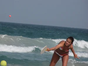 Skinny and sexy lady in a bikini playing on the beach