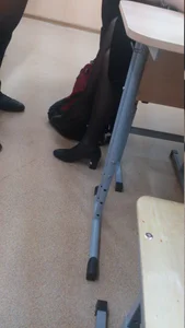 Crossed Skinny Legs in Black Pantyhose - Photo in Class